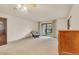 A neutral living room with a sliding door to the sunroom at 13800 E Marina Dr # 112, Aurora, CO 80014