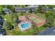 This aerial view shows community amenities including a pool and tennis court surrounded by lush landscaping at 6856 S Broadway, Centennial, CO 80122