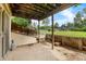 Enjoy the outdoors on this charming back porch with concrete floors and lush landscaping at 6856 S Broadway, Centennial, CO 80122