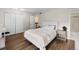 Well-lit bedroom with hardwood floors, multiple closets and ensuite bathroom at 6856 S Broadway, Centennial, CO 80122