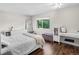 Bright bedroom with hardwood floors, and large window for natural light at 6856 S Broadway, Centennial, CO 80122