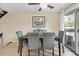 Well-lit dining room features a modern ceiling fan, and a sliding glass door to the outside at 6856 S Broadway, Centennial, CO 80122