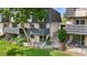 Charming townhome exterior with mature landscaping and a well-maintained lawn at 6856 S Broadway, Centennial, CO 80122