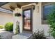 Close-up of the front door with a hanging flower basket and visible house number at 6856 S Broadway, Centennial, CO 80122