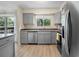 Bright kitchen featuring stainless steel appliances, gray cabinets, and granite countertops at 6856 S Broadway, Centennial, CO 80122