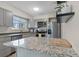 Bright kitchen featuring stainless steel appliances, gray cabinets, and granite countertops at 6856 S Broadway, Centennial, CO 80122
