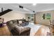 Cozy living room features a large sectional, a sliding glass door and tile floors at 6856 S Broadway, Centennial, CO 80122
