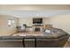 Basement living room includes a fireplace, a television, and a large sectional sofa at 6856 S Broadway, Centennial, CO 80122