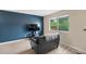 Comfortable living area with blue accent wall, contemporary furnishings, and bright window at 6856 S Broadway, Centennial, CO 80122
