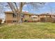 Backyard with large tree, patio, grill, furniture and well-maintained grass at 4940 Fenton St, Denver, CO 80212
