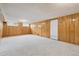 Carpeted basement with wood paneled walls and bright natural lighting at 4940 Fenton St, Denver, CO 80212