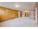 Spacious basement area with wood paneled walls, carpet and built-in closet at 4940 Fenton St, Denver, CO 80212