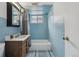 Blue tiled bathroom features vanity, mirror, bath tub and shower at 4940 Fenton St, Denver, CO 80212