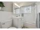 Bathroom featuring a vanity, toilet, and bathtub with glass doors at 4940 Fenton St, Denver, CO 80212