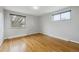 A bedroom featuring hardwood floors and two windows for natural light at 4940 Fenton St, Denver, CO 80212