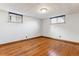 Sunny bedroom with hardwood floors and two windows providing natural light at 4940 Fenton St, Denver, CO 80212