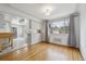 An open dining area features a light fixture, hardwood floors, and access to the kitchen at 4940 Fenton St, Denver, CO 80212