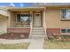 Charming front porch with brick accents, iron railings, and a mid-century modern feel at 4940 Fenton St, Denver, CO 80212