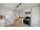 A kitchen featuring stainless steel appliances and white cabinets, open to another room at 4940 Fenton St, Denver, CO 80212