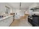 Open concept kitchen with stainless appliances and views of another room at 4940 Fenton St, Denver, CO 80212