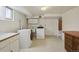 Functional laundry area features appliances, storage and checkered tile flooring at 4940 Fenton St, Denver, CO 80212