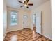 Bright bedroom featuring hardwood floors, a ceiling fan, and ample natural light from the large window at 66 E 45Th Ave, Denver, CO 80216