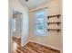 Bright bedroom with wood-look floors, a large window, and a closet offers comfort and style at 66 E 45Th Ave, Denver, CO 80216