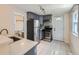Updated kitchen with stainless steel appliances, ample cabinet space, and tile flooring at 66 E 45Th Ave, Denver, CO 80216