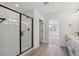 Clean bathroom with glass shower, white tile, and large vanity with black fixtures at 1324 Sienna Peak Cir, Erie, CO 80516