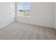 Well lit bedroom with carpeted floor and two windows providing plenty of natural light at 1324 Sienna Peak Cir, Erie, CO 80516