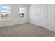 Bright bedroom with carpeted floor and large windows providing plenty of natural light at 1324 Sienna Peak Cir, Erie, CO 80516