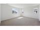 Bright bedroom with carpeted floor and large windows providing plenty of natural light at 1324 Sienna Peak Cir, Erie, CO 80516