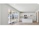 Modern kitchen with white cabinets, stainless steel appliances, and a large sliding glass door to the backyard at 1324 Sienna Peak Cir, Erie, CO 80516