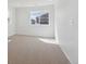 Bedroom with neutral carpet, white walls, and a large window with lots of natural light at 1324 Sienna Peak Cir, Erie, CO 80516