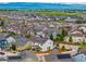 Panoramic aerial view of a neighborhood with homes featuring solar panels and mountain views at 2679 Leafdale Cir, Castle Rock, CO 80109
