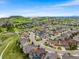 Aerial view of a well-planned community with lush green spaces, winding roads, and diverse home styles under a blue sky at 2679 Leafdale Cir, Castle Rock, CO 80109