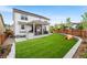 Expansive backyard featuring a lush lawn, a covered patio, and a play structure at 2679 Leafdale Cir, Castle Rock, CO 80109
