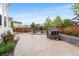 Spacious backyard with a large patio, a built-in fire pit, and a playhouse at 2679 Leafdale Cir, Castle Rock, CO 80109