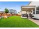 Well-maintained backyard featuring a turf lawn, a covered patio, and a play structure at 2679 Leafdale Cir, Castle Rock, CO 80109