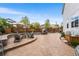 Well-designed backyard with a stone fire pit, comfortable seating, and mature trees at 2679 Leafdale Cir, Castle Rock, CO 80109