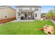 Spacious backyard featuring a turf lawn, a covered patio, and a play structure at 2679 Leafdale Cir, Castle Rock, CO 80109