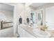 Bright bathroom with a double sink vanity and neutral walls featuring a doorway leading to bedroom at 2679 Leafdale Cir, Castle Rock, CO 80109