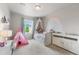 Bright bedroom featuring a rainbow mural and a cozy bed with a decorative canopy and tent at 2679 Leafdale Cir, Castle Rock, CO 80109
