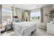 Sunlit bedroom with a canopy bed, accent wall with plants, and multiple windows for natural light at 2679 Leafdale Cir, Castle Rock, CO 80109