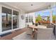 Cozy covered patio with a wooden table, wicker chairs, and string lights overhead at 2679 Leafdale Cir, Castle Rock, CO 80109
