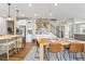 The dining area has a view of the kitchen, bar, and staircase; features a wooden table and seating for four at 2679 Leafdale Cir, Castle Rock, CO 80109