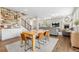 Open-concept dining area with wood table, a wet bar, and a living room with fireplace in the background at 2679 Leafdale Cir, Castle Rock, CO 80109