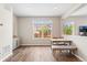 Inviting dining area with hardwood floors, natural light, a modern table and bench, creating a cozy atmosphere at 2679 Leafdale Cir, Castle Rock, CO 80109