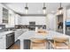 An island kitchen with white cabinets, stainless steel appliances, pendant lighting, and modern fixtures at 2679 Leafdale Cir, Castle Rock, CO 80109