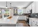 Bright kitchen featuring white cabinets, a modern island, stainless steel appliances, and tiled backsplash at 2679 Leafdale Cir, Castle Rock, CO 80109